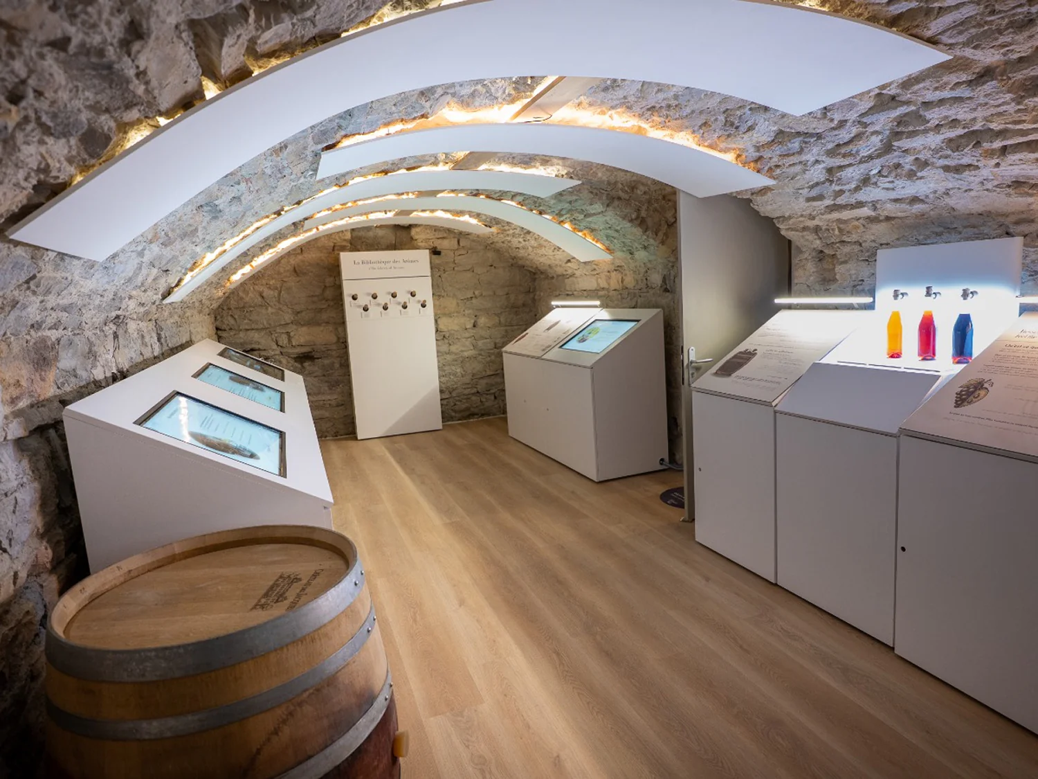 Interactive kiosks installed in the museum's stone-vaulted exhibition room